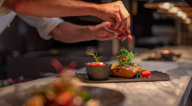 Chef Garnishing a Salmon Dish